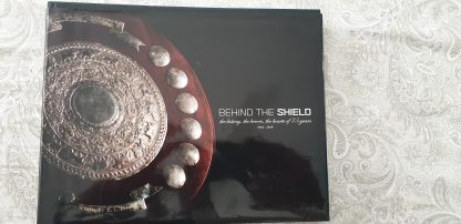 "BEHIND THE SHIELD"